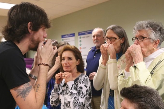 PHOTO: Chris Janson teaching harmonica to Harmonicas for Health Participants living with COPD (Photo Credit: Helen Comer)