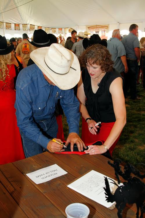 St. Paul resident Sue Coleman (on the right) helps with a St. Paul Rodeo activity. She volunteers in a number of ways at the St. Paul Rodeo. Coleman grew up helping at the rodeo with her parents. Photo by Hoot Creek.
