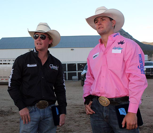 Team ropers Clint Summers, left, and Dustin Egusquiza look over the arena after winning the Rooftop Rodeo title Monday night. (LYNETTE HARBIN PHOTO)