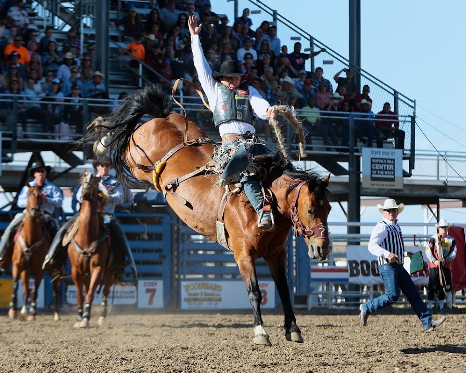 Jake Wright won the saddle bronc riding at the Cody Stampede with this 88-point ride on Frontier Rodeo’s Short Stop. – Cody Stampede photo by Andy Watson/prcaphotos.com