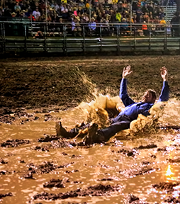 Rodeo announcer Tim Fuller splashes down after the Mandan Rodeo crowd raised $2,200 for K9s for Warriors to challenge him. Photo by Jackie Jensen