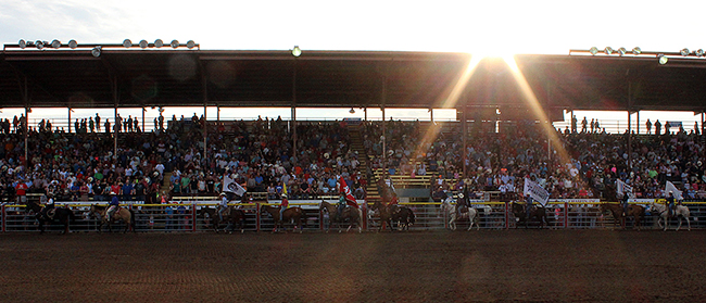 The grand entry parades in front of a pack grandstands during one of the performances of the 2015 Dodge City Roundup Rodeo. The annual event celebrates its 40th year in 2016.
