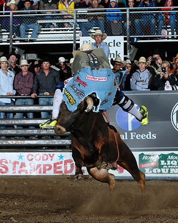 Dusty Tuckness attempts to jump his bull during Thursday’s Bullfighters Only competition on conjunction with the Cody/Yellowstone Xtreme Bulls. Tuckness scored a season-high 91.5 points to win the title. (ANDY WATSON PHOTO)