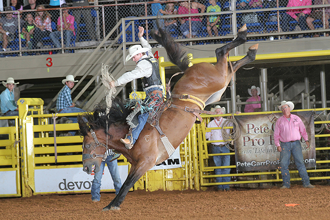 CoBurn Bradshaw rides Pete Carr’s Cowboy Cowtown for 84 points Thursday night to take the lead at the saddle bronc riding lead at the Lea County Fair and Rodeo. (PEGGY GANDER PHOTO)