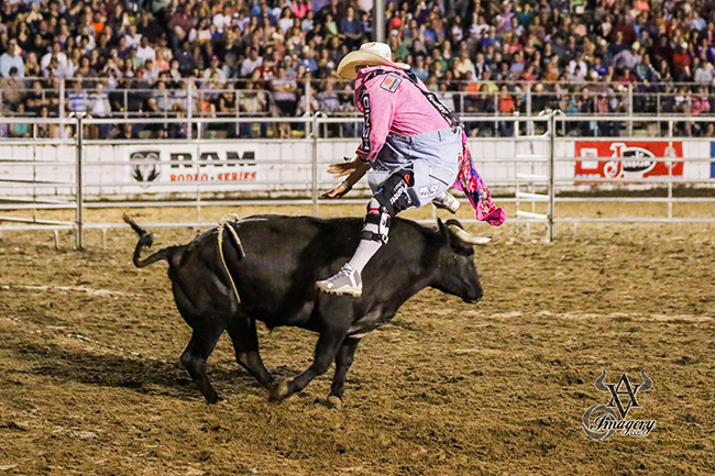 Chuck Swisher jumps his Hookin A Ranch bull to begin his fight during the championship round of the Bullfighters Only tour stop in Sidney, Iowa. Swisher scored 85 points to win the title. (PHILLIP AVIONE PHOTO)