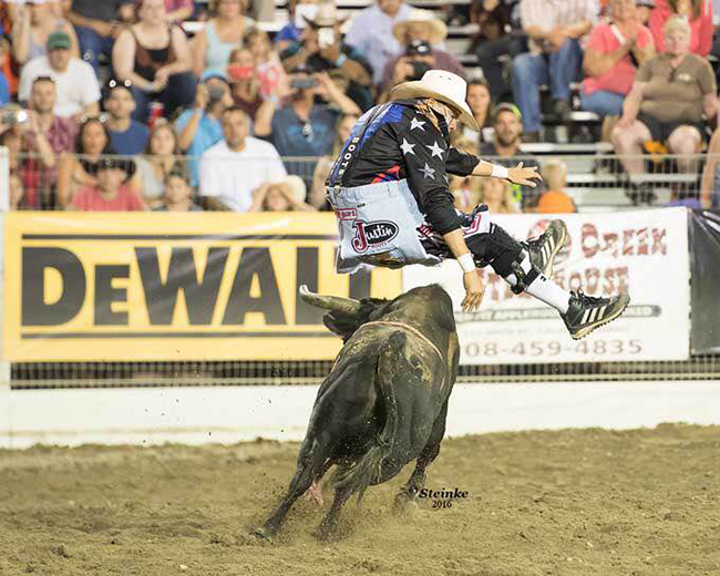 Cody Webster jumps his bull, Little Foot, during Tuesday’s Bullfighters Only tour event in conjunction with the Caldwell Night Rodeo. Webster won the event with an 89.5-point fight. (KIRT STIENKE PHOTO)