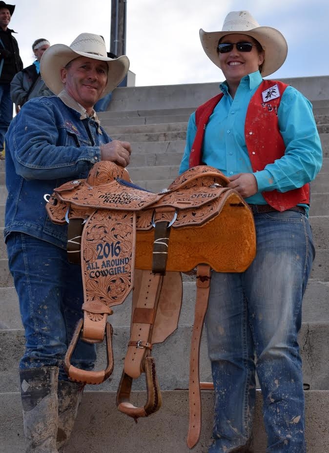 Shelbie Weeder (right) with Coach Robert Etbauer as she receives the All-Around Champion Cowgirl saddle at the Doc Gardner Rodeo this past spring. Weeder will now serve as the assistant Women’s Rodeo Coach at Panhandle State. —Courtesy photo